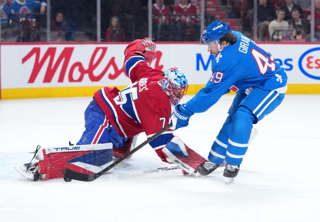 Montreal Canadiens goalie Jakub Dobes (75) stops Colorado Avalanche defenseman Samuel Girard (49) during the second period at the Bell Centre. Mandatory Credit: Eric Bolte-Imagn Images