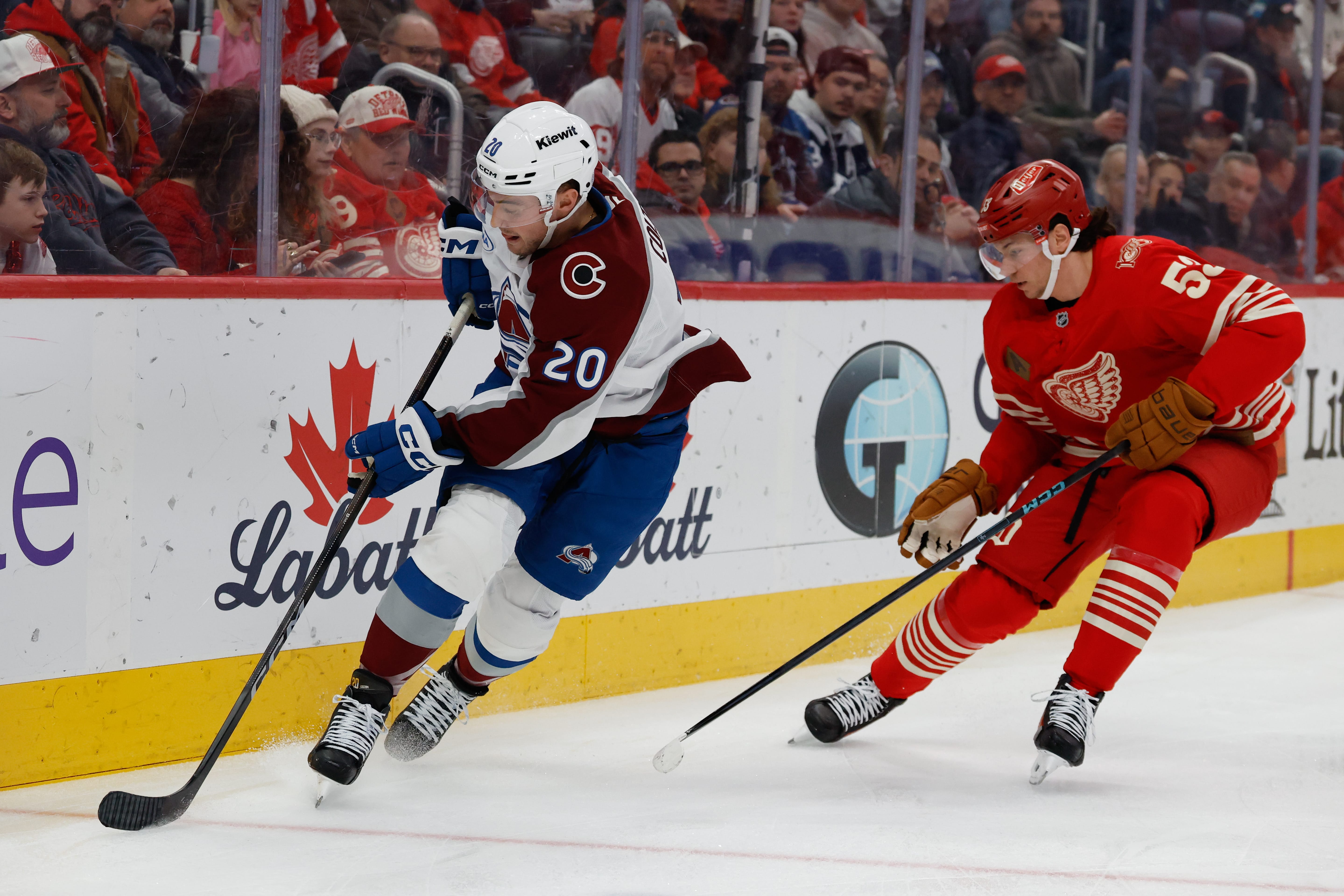 Colorado Avalanche center Ross Colton (20) skates against Detroit Red Wings defenseman Moritz Seider (53) in the first period at Little Caesars Arena. Mandatory Credit: Rick Osentoski-Imagn Images