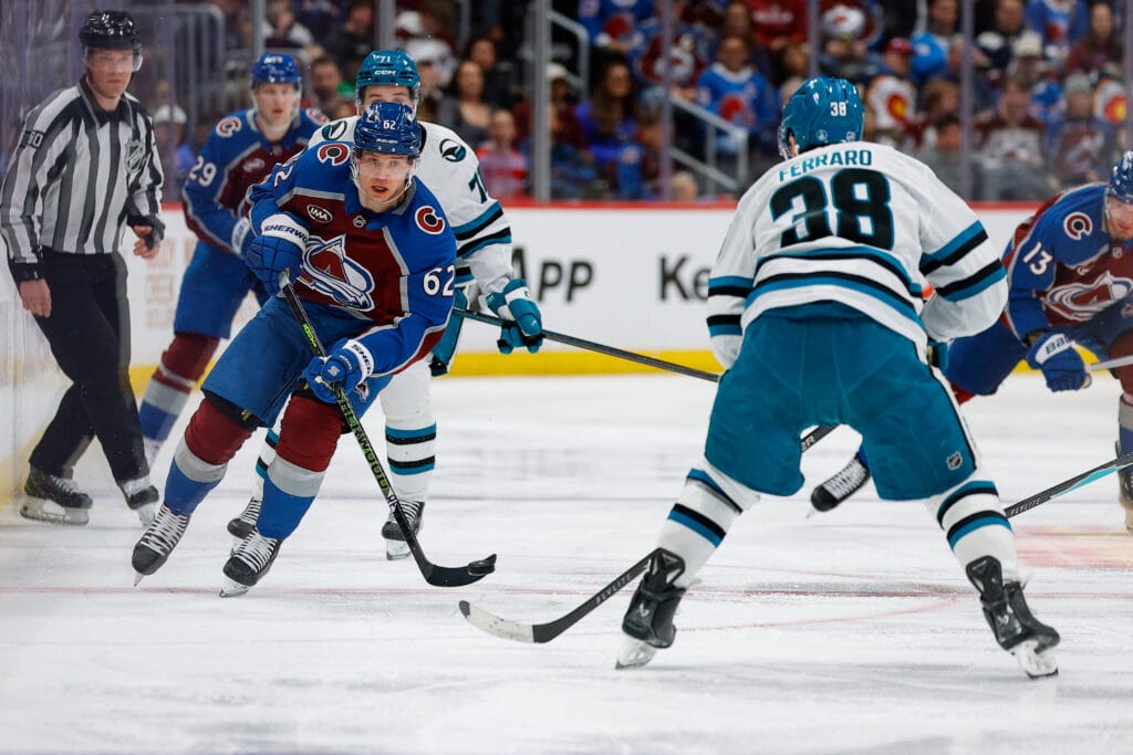 Colorado Avalanche left wing Artturi Lehkonen (62) plays the puck forward against San Jose Sharks defenseman Mario Ferraro (38) in the second period at Ball Arena. Mandatory Credit: Isaiah J. Downing-Imagn Images
