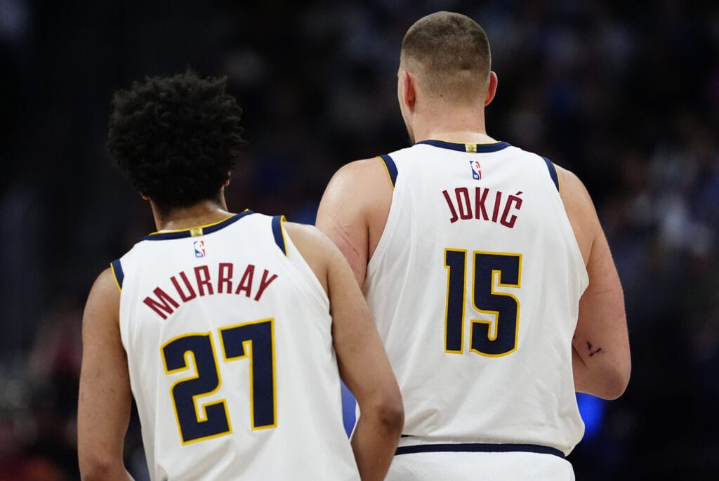 Jamal Murray (27) and Nikola Jokić (15) of the Denver Nuggets stand side-by-side