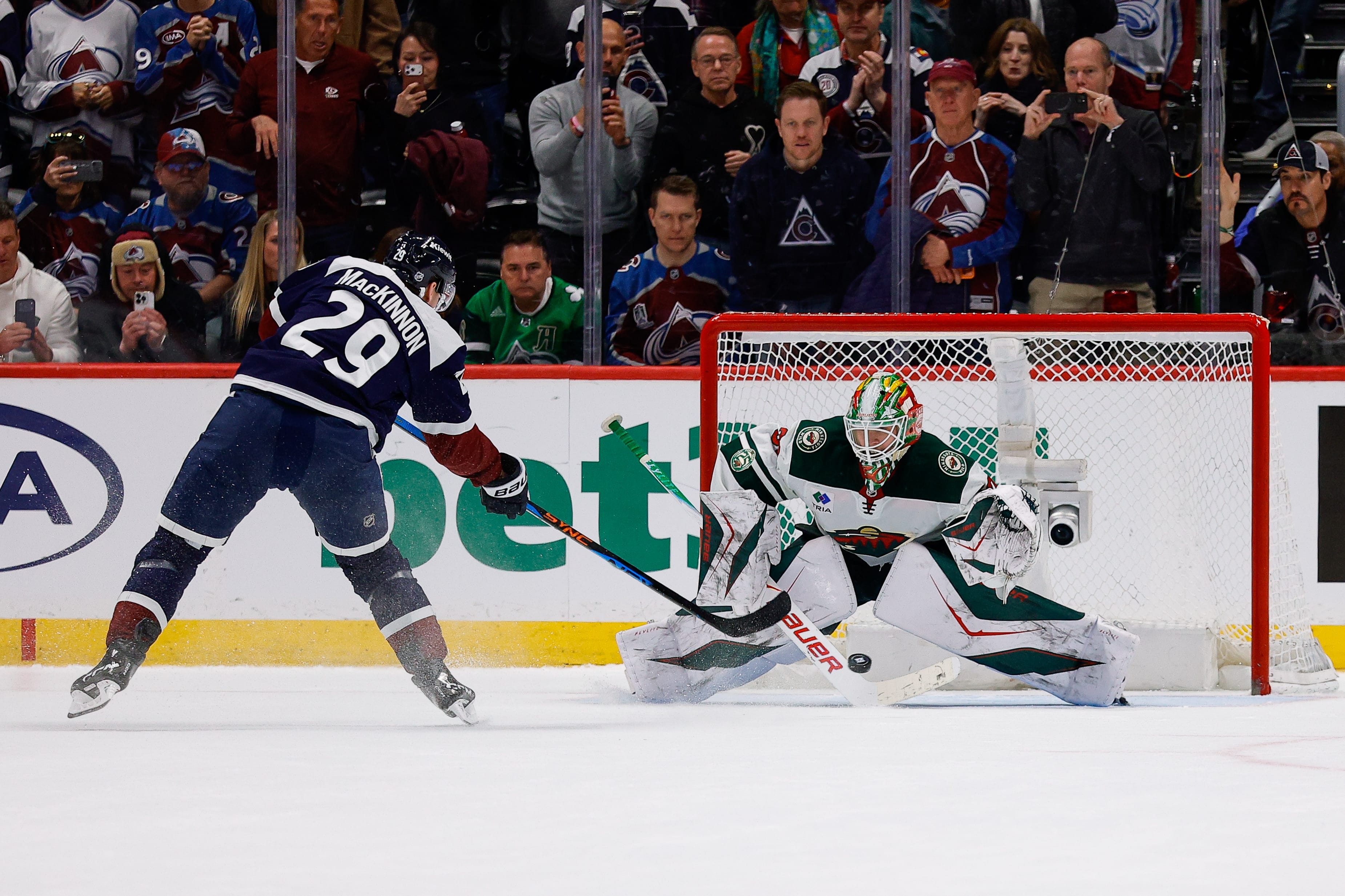 Colorado Avalanche center Nathan MacKinnon (29) scores a shootout goal against Minnesota Wild goaltender Jesper Wallstedt (30) at Ball Arena. Mandatory Credit: Isaiah J. Downing-Imagn Images