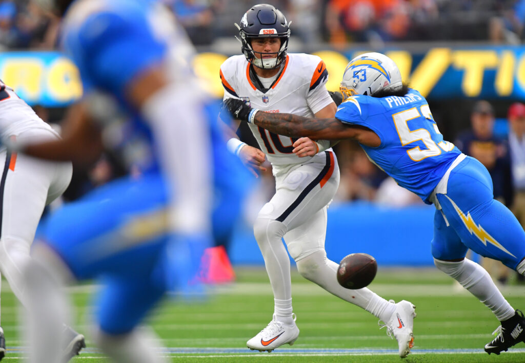Oct 11, 2026; Inglewood, California, USA; Denver Broncos quarterback Bo Nix (10) is pressured by Los Angeles Chargers linebacker Del'Shawn Phillips (53) during the second half at SoFi Stadium. Mandatory Credit: Gary A. Vasquez-Imagn Images