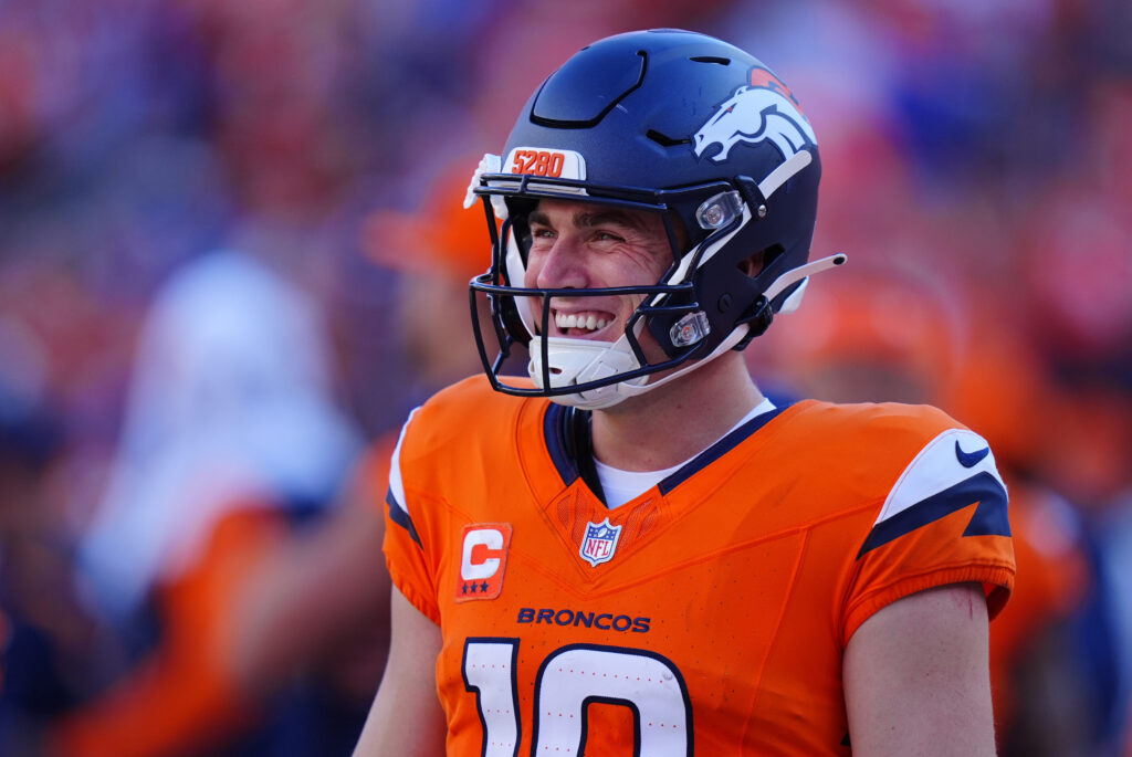 Sep 20, 2026; Denver, Colorado, USA; Denver Broncos quarterback Bo Nix (10) smiles on the sidelines during the fourth quarter against the Jacksonville Jaguars at Empower Field at Mile High. Mandatory Credit: Ron Chenoy-Imagn Images