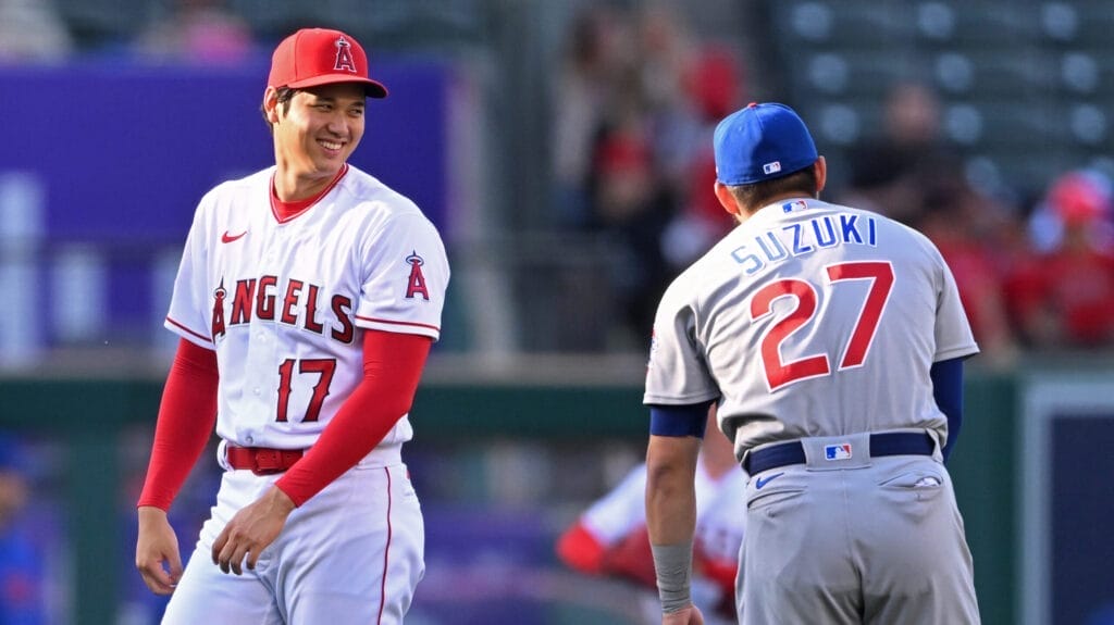 Los Angeles Angels designated hitter Shohei Ohtani (17) talks with Chicago Cubs right fielder Seiya Suzuki (27)
