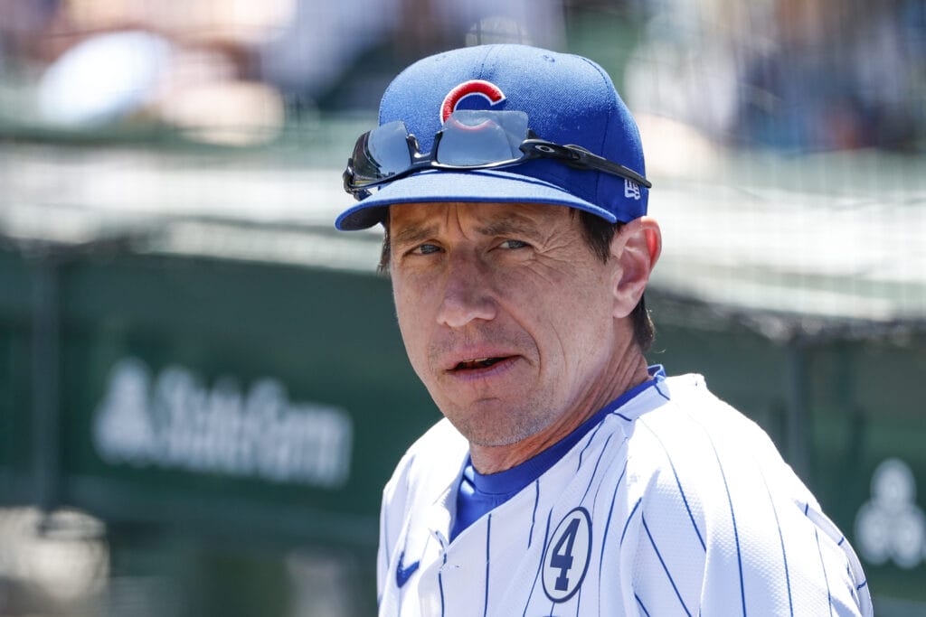 Chicago Cubs manager Craig Counsell (30) looks on from the dugout before a baseball game against the Cincinnati Reds at Wrigley Field.
