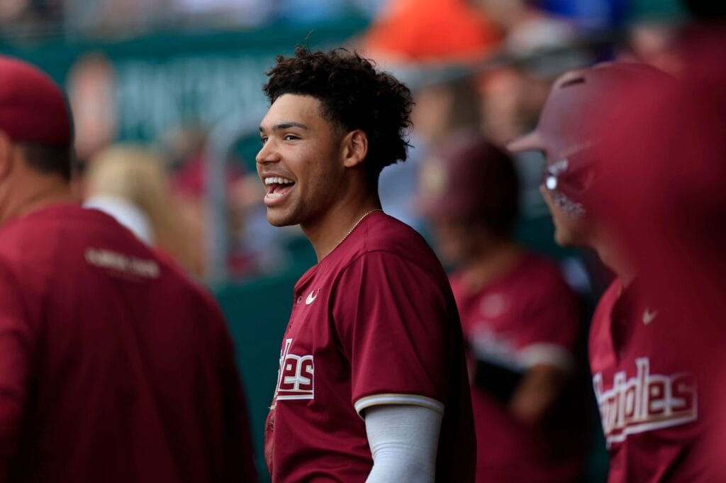 Florida State infielder Cam Smith (24) looks on from the dugout in-between the second and third innings of an NCAA baseball matchup at 121 Financial Ballpark in Jacksonville, Fla. Smith was drafted by the Chicago Cubs in the first round of the 2024 MLB Draft.