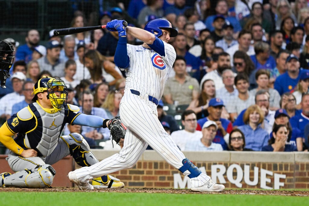 Chicago Cubs first base Michael Busch (29) hits an RBI single against the Milwaukee Brewers during the third inning at Wrigley Field.