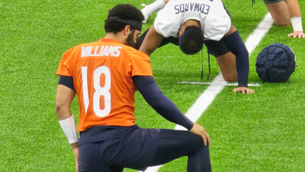 Bears QB Caleb Williams stretches before team drills at Halas Hall.