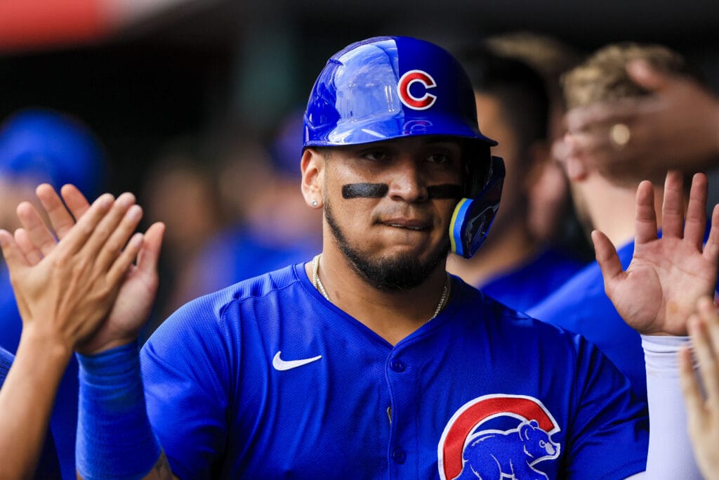 Chicago Cubs third baseman Isaac Paredes (17) high fives teammates after scoring on a two-run double hit by outfielder Seiya Suzuki (not pictured) in the third inning against the Cincinnati Reds at Great American Ball Park.