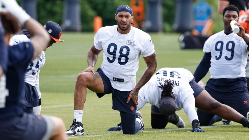 Bears defense lineman Montez Sweat stretches on the field at Halas Hall in minicamp