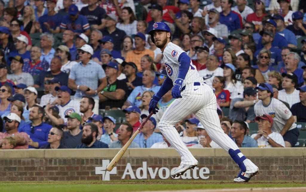 Chicago Cubs outfielder Cody Bellinger (24) hits a one run sacrifice against the St. Louis Cardinals during the fifth inning at Wrigley Field.