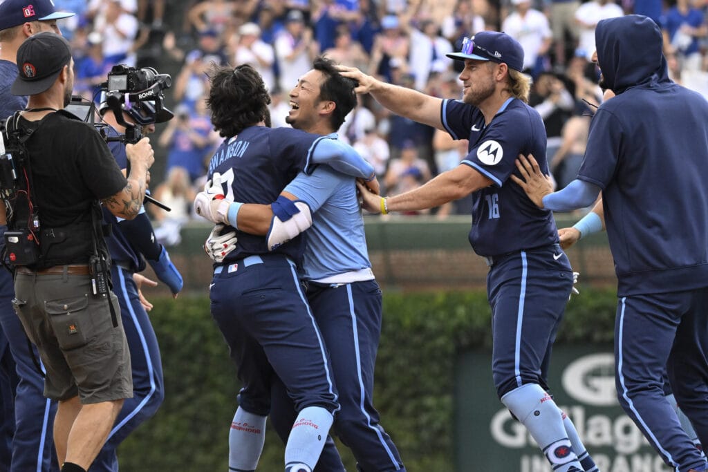 Chicago Cubs outfielder Seiya Suzuki (27) celebrates with shortstop Dansby Swanson (7) after hitting the game winning RBI single against the Toronto Blue Jays during the tenth inning at Wrigley Field.