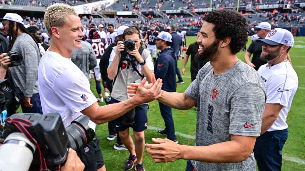 Bears QB Caleb Williams greets Bengals QB Joe Burrow at midfield after preseason game.