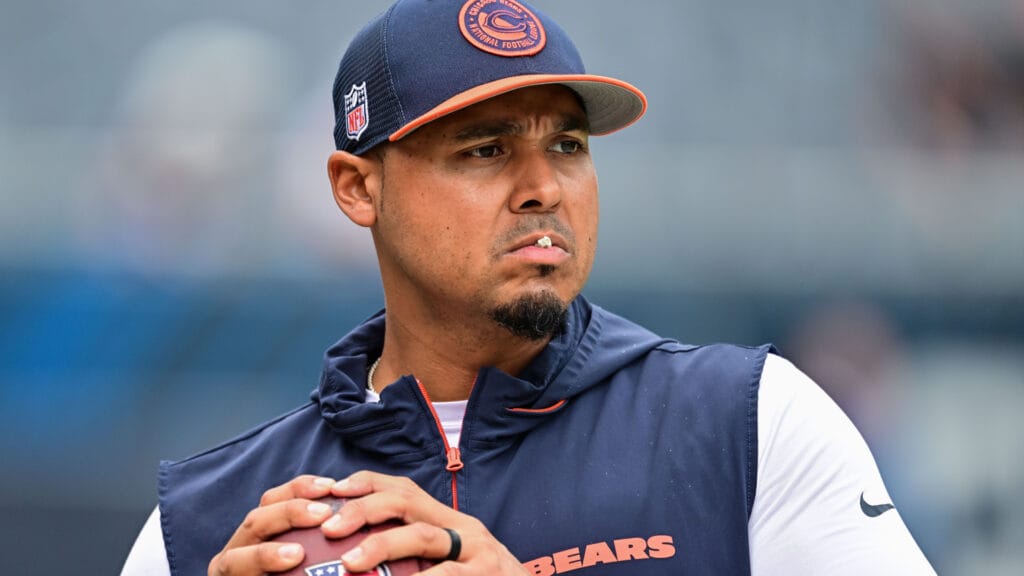 Bears' GM Ryan Poles playing catch on the sideline before a preseason game.