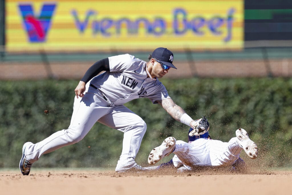 Chicago Cubs second baseman Nico Hoerner (2) is caught stealing second base by New York Yankees second baseman Gleyber Torres (25) during the fourth inning at Wrigley Field.