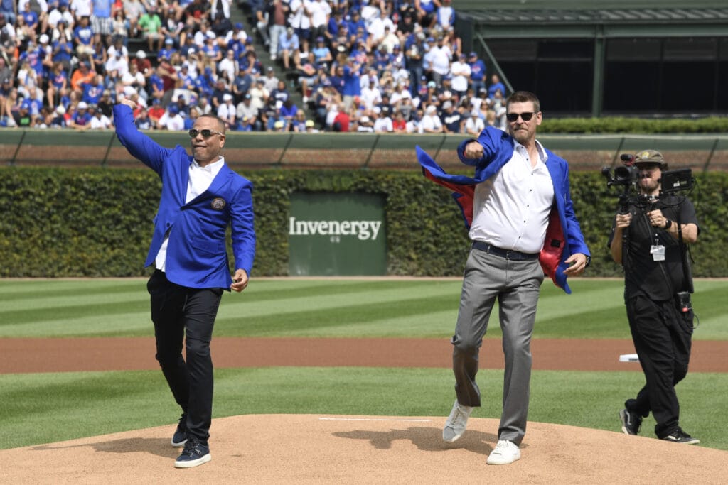 Former Chicago Cubs players Kerry Wood, right, and Aramis Ramirez throw out ceremonial first pitches after a Chicago Cubs Hall of Fame ceremony before the team’s game against the New York Yankees before at Wrigley Field.