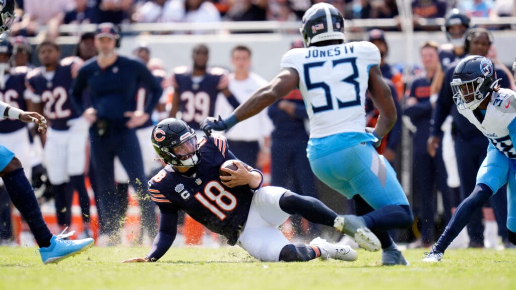 Bears' quarterback Caleb Williams slides to avoid a hit against the Titans