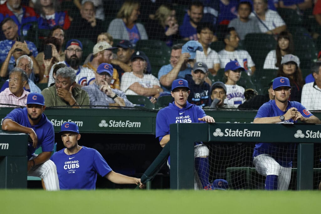 Chicago Cubs manager Craig Counsell (2-R) looks on from the dugout during the ninth inning of a baseball game against the Oakland Athletics at Wrigley Field.