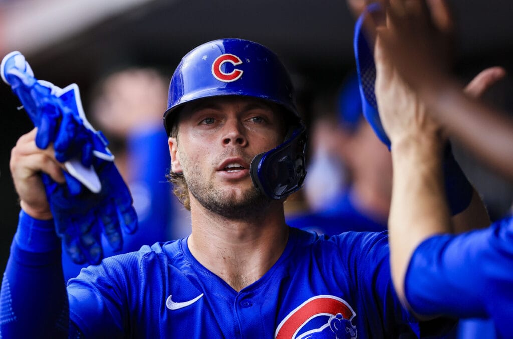 Chicago Cubs second baseman Nico Hoerner (2) high fives teammates after scoring on a RBI single hit by catcher Christian Bethancourt (not pictured) in the second inning against the Cincinnati Reds at Great American Ball Park.