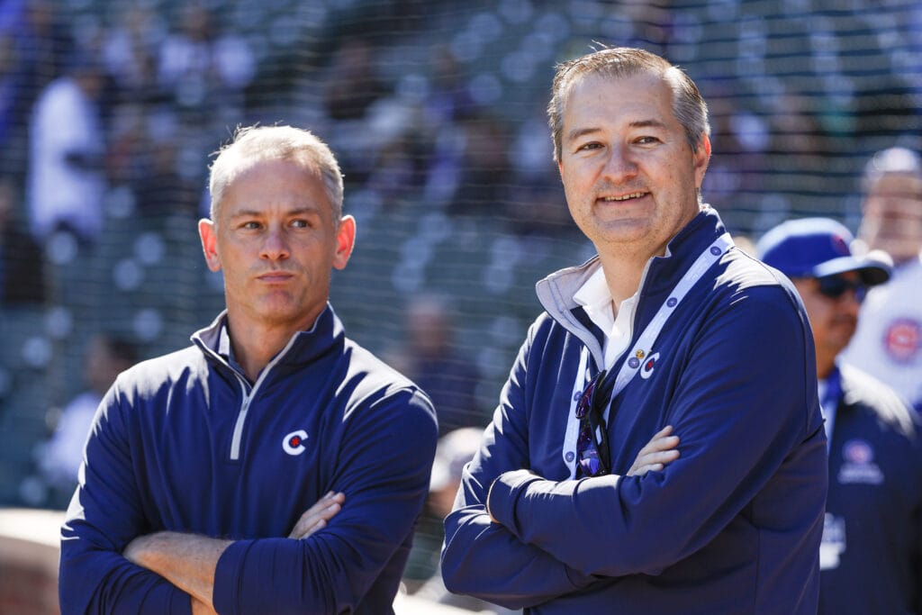 Chicago Cubs Chairman Tom Ricketts (R) smiles next to Chicago Cubs President of baseball operations Jed Hoyer (L) before a baseball game between the Chicago Cubs and Cincinnati Reds at Wrigley Field. A crucial MLB offseason awaits the Cubs.