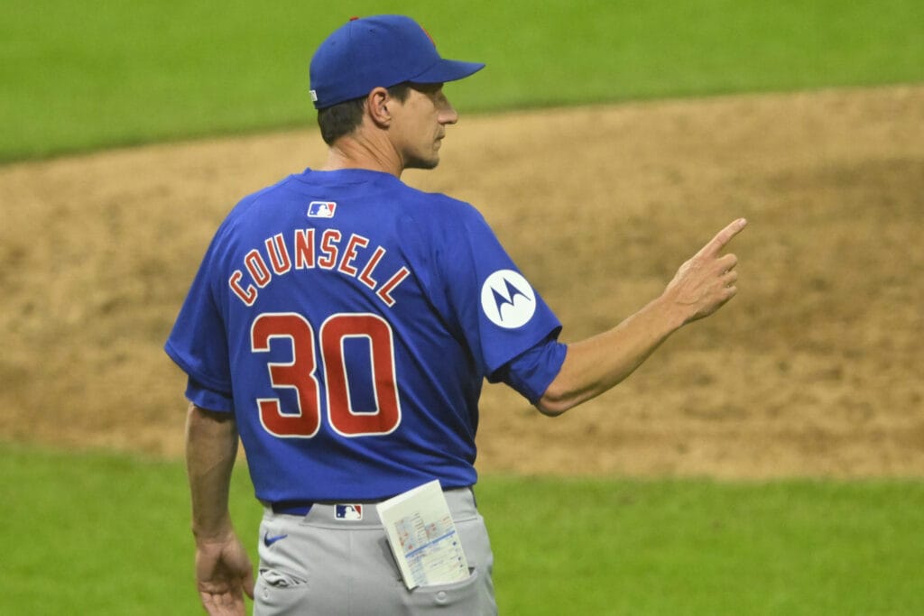 Chicago Cubs manager Craig Counsell (30) makes a call to the bullpen in the eighth inning against the Cleveland Guardians at Progressive Field.