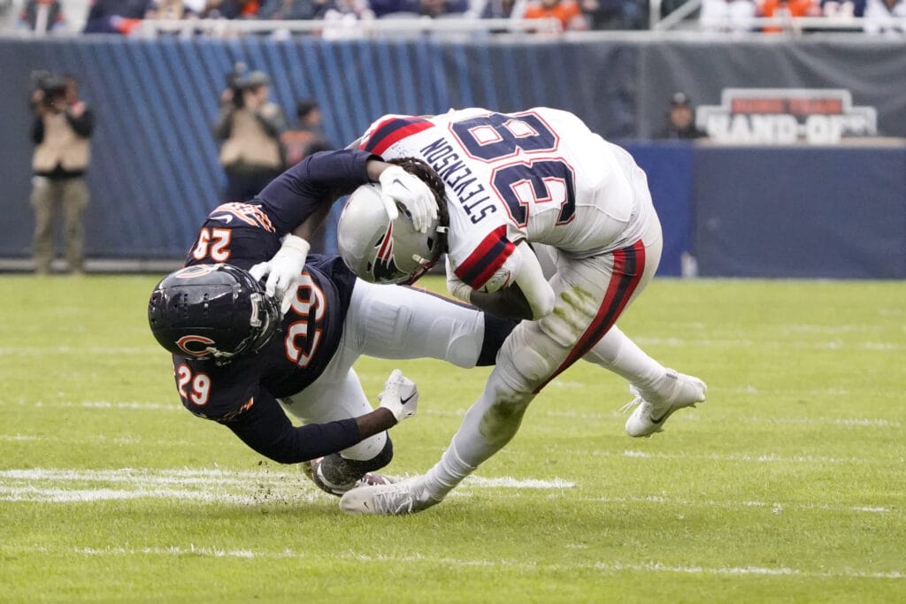 Chicago Bears' Tyrique Stevenson stiff-armed by New England's Rhamondre Stevenson
