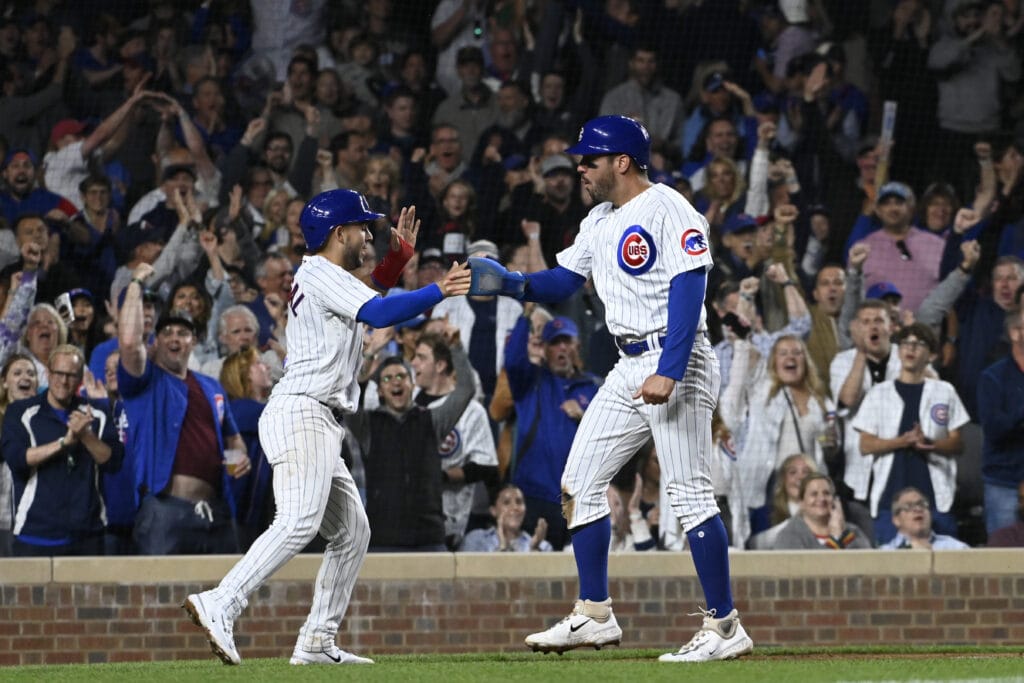 Chicago Cubs center fielder Mike Tauchman (40) high fives Chicago Cubs third baseman Nick Madrigal (1) after they scored against the Pittsburgh Pirates during the sixth inning at Wrigley Field.