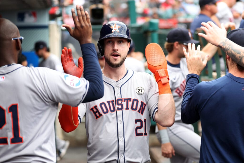 Houston Astros right fielder Kyle Tucker (21) is greeted in the dugout after scoring a run during the fourth inning against the Los Angeles Angels at Angel Stadium.