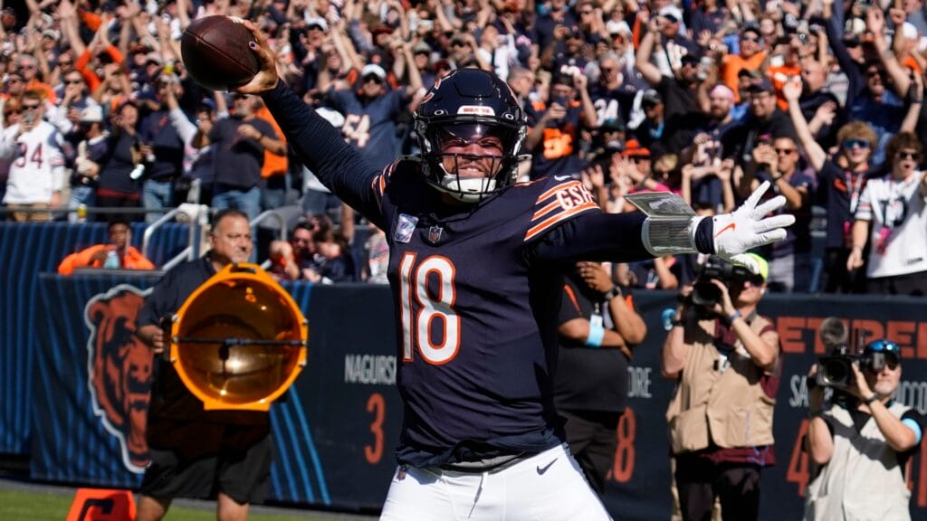 Chicago Bears quarterback Caleb Williams spiking a ball after a touchdown