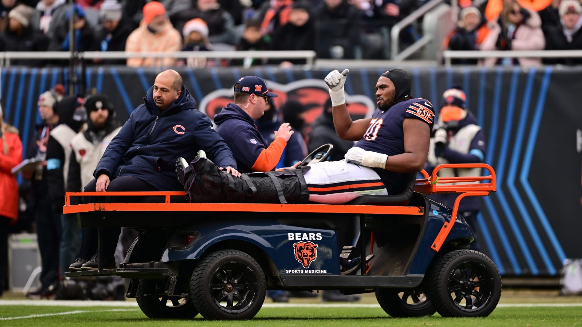 Chicago, Illinois, USA; Chicago Bears offensive tackle Braxton Jones (70) is carted off the field against the Detroit Lions during the second quarter at Soldier Field.