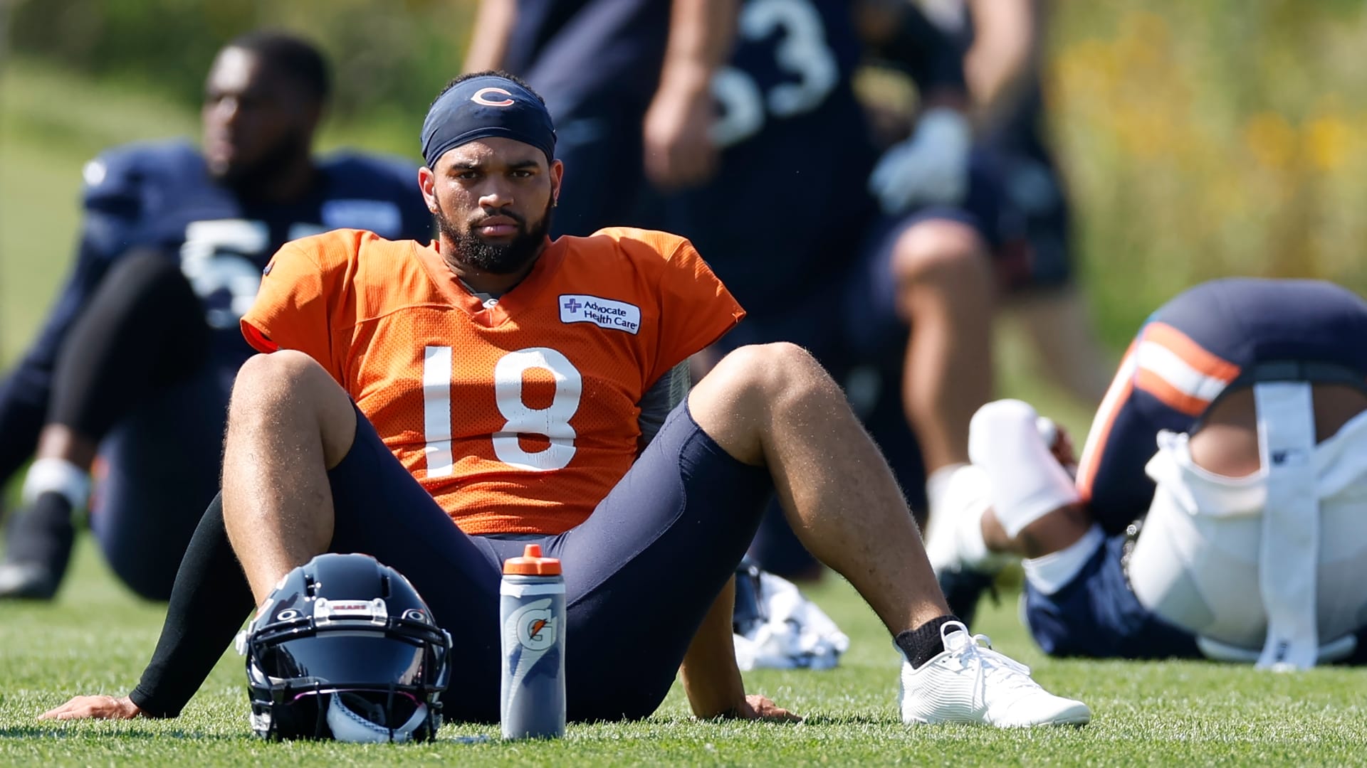 Chicago Bears quarterback Caleb Williams (18) sits on the field during joint training camp practice with the Miami Dolphins ahead of Sunday's preseason opener.