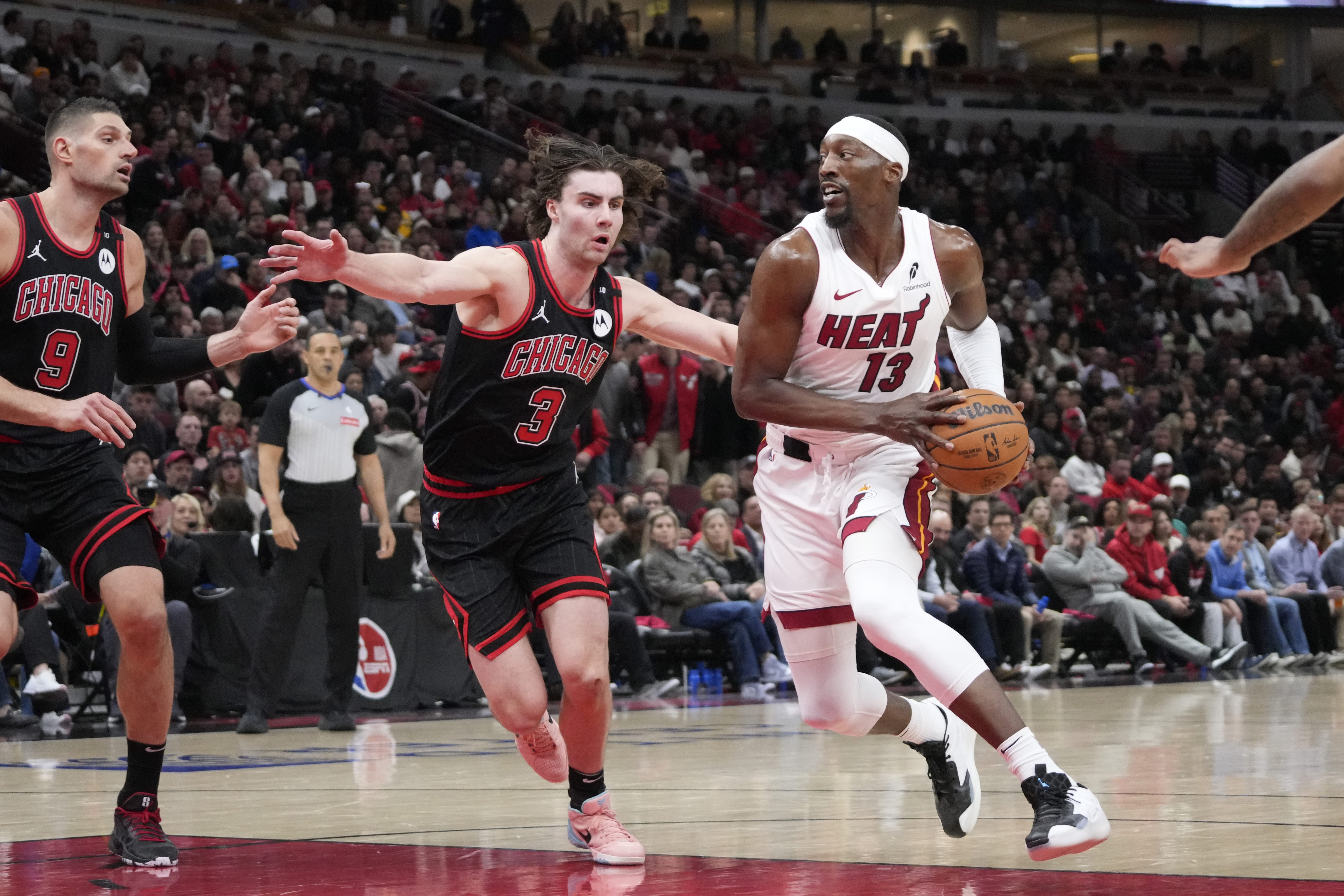 Chicago Bulls guard Josh Giddey (3) defends Miami Heat center Bam Adebayo (13) during the second half at United Center.