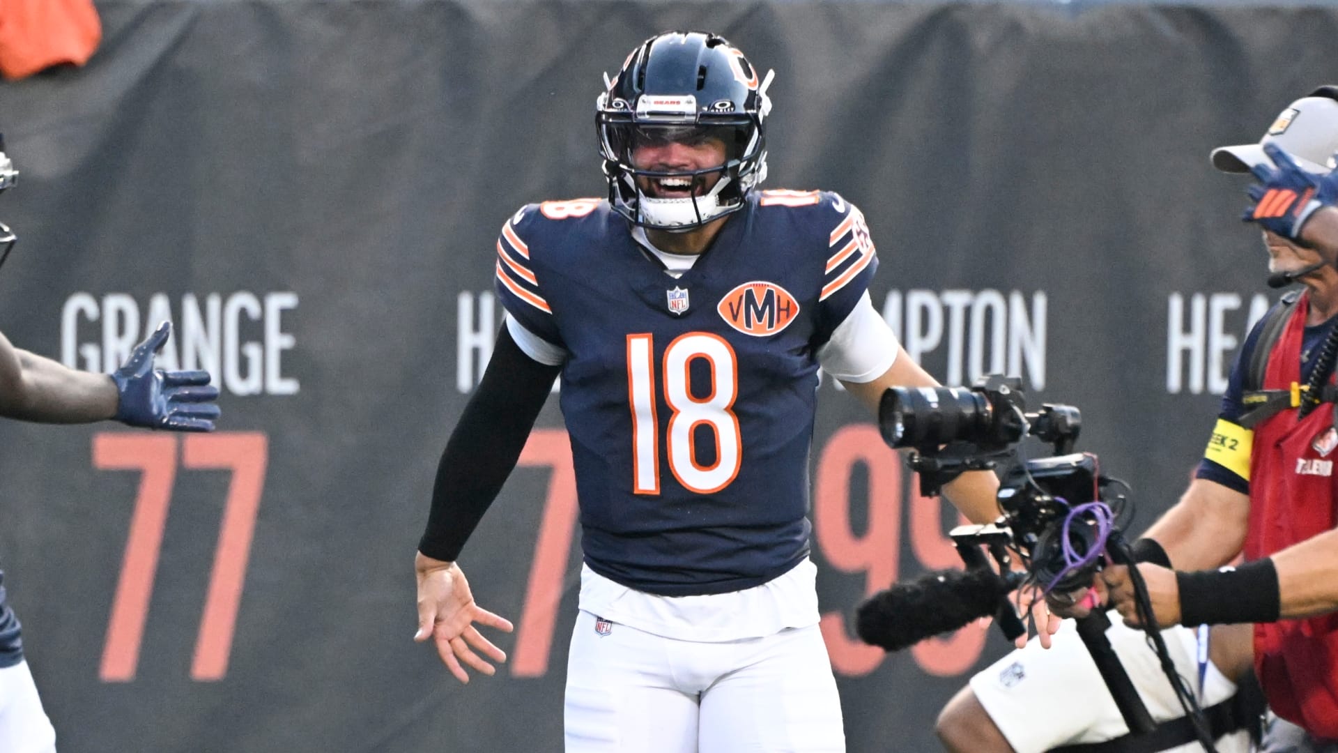 Chicago Bears wide receiver Olamide Zaccheaus (14) celebrates with Chicago Bears quarterback Caleb Williams (18) after scoring a touchdown against the Buffalo Bills during the first half at Soldier Field.