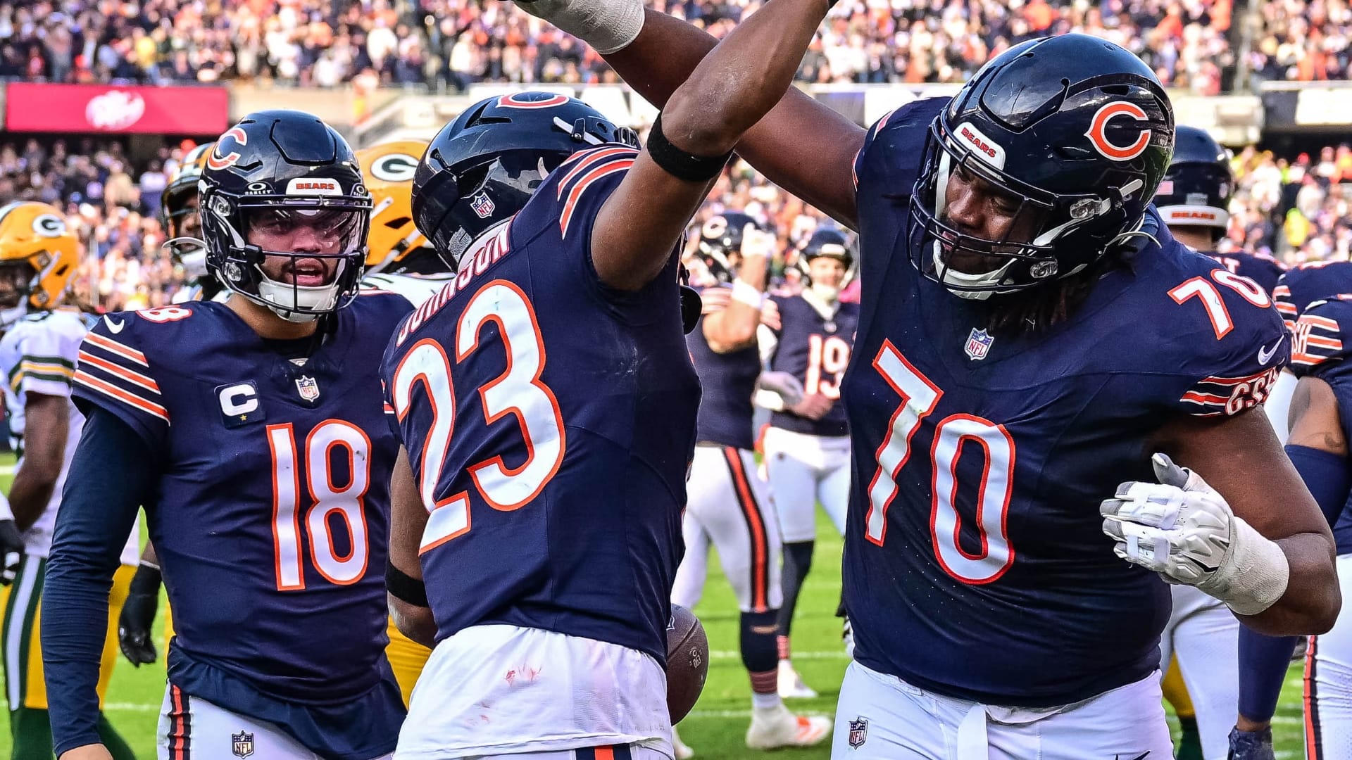 Chicago Bears running back Roschon Johnson (23) celebrates his rushing touchdown with offensive tackle Braxton Jones (70) against the Green Bay Packers during the second quarter at Soldier Field.