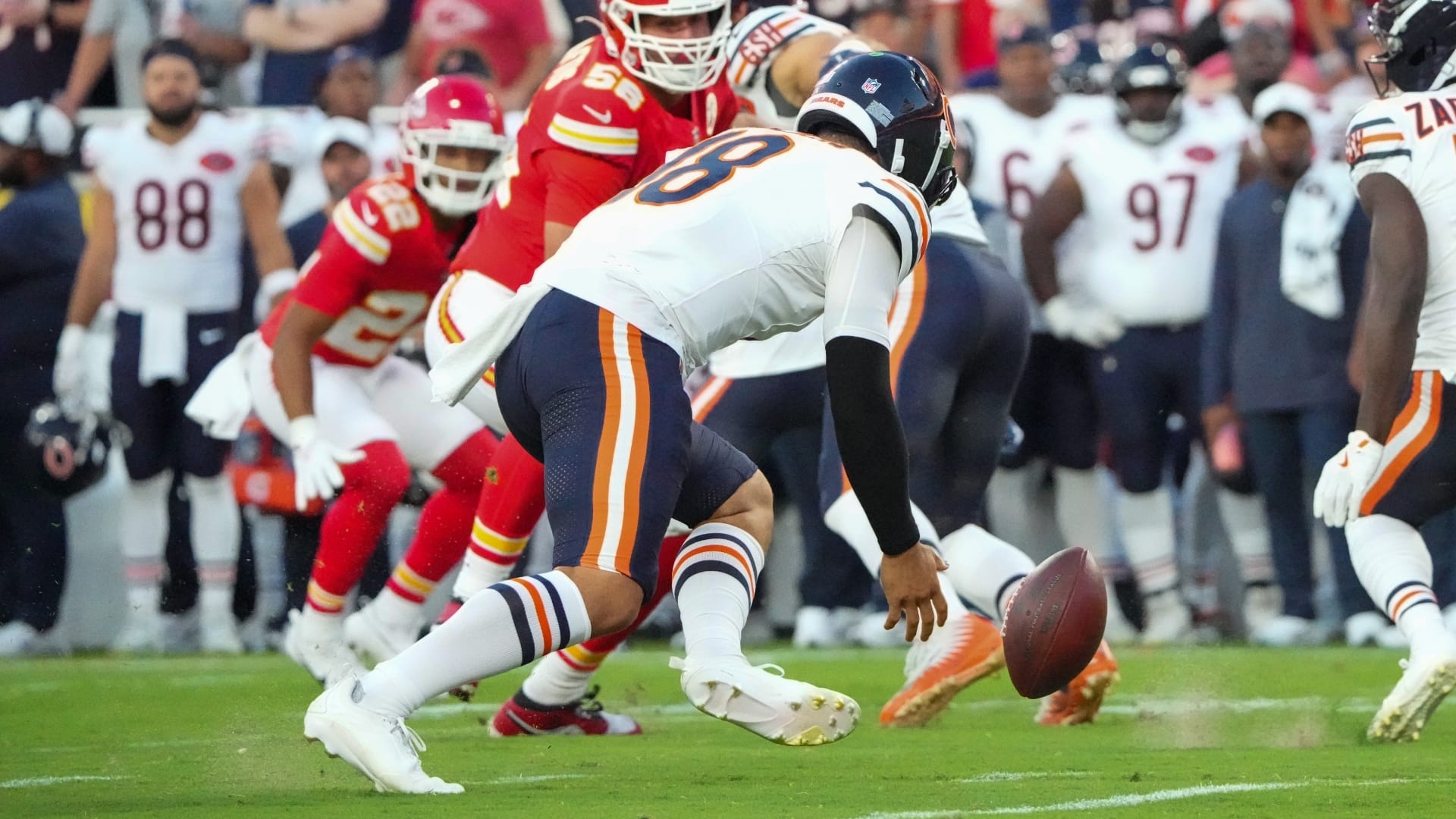 Chicago Bears quarterback Caleb Williams (18) fumbles a handoff against the Chicago Bears during the first half of the game at GEHA Field at Arrowhead Stadium.