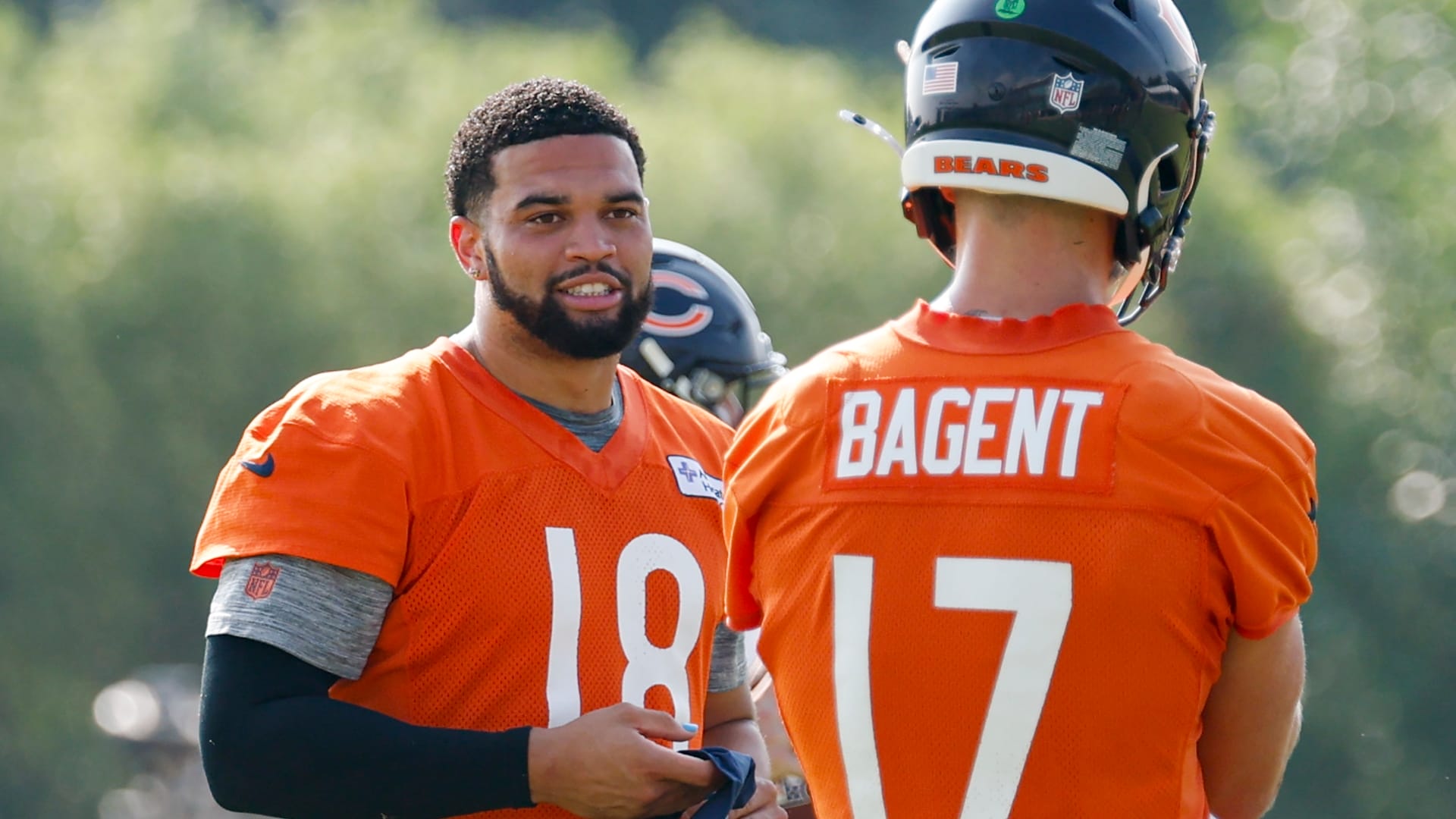 Chicago Bears quarterback Caleb Williams (18) chats with quarterback Tyson Bagent (17) during training camp at Halas Hall.