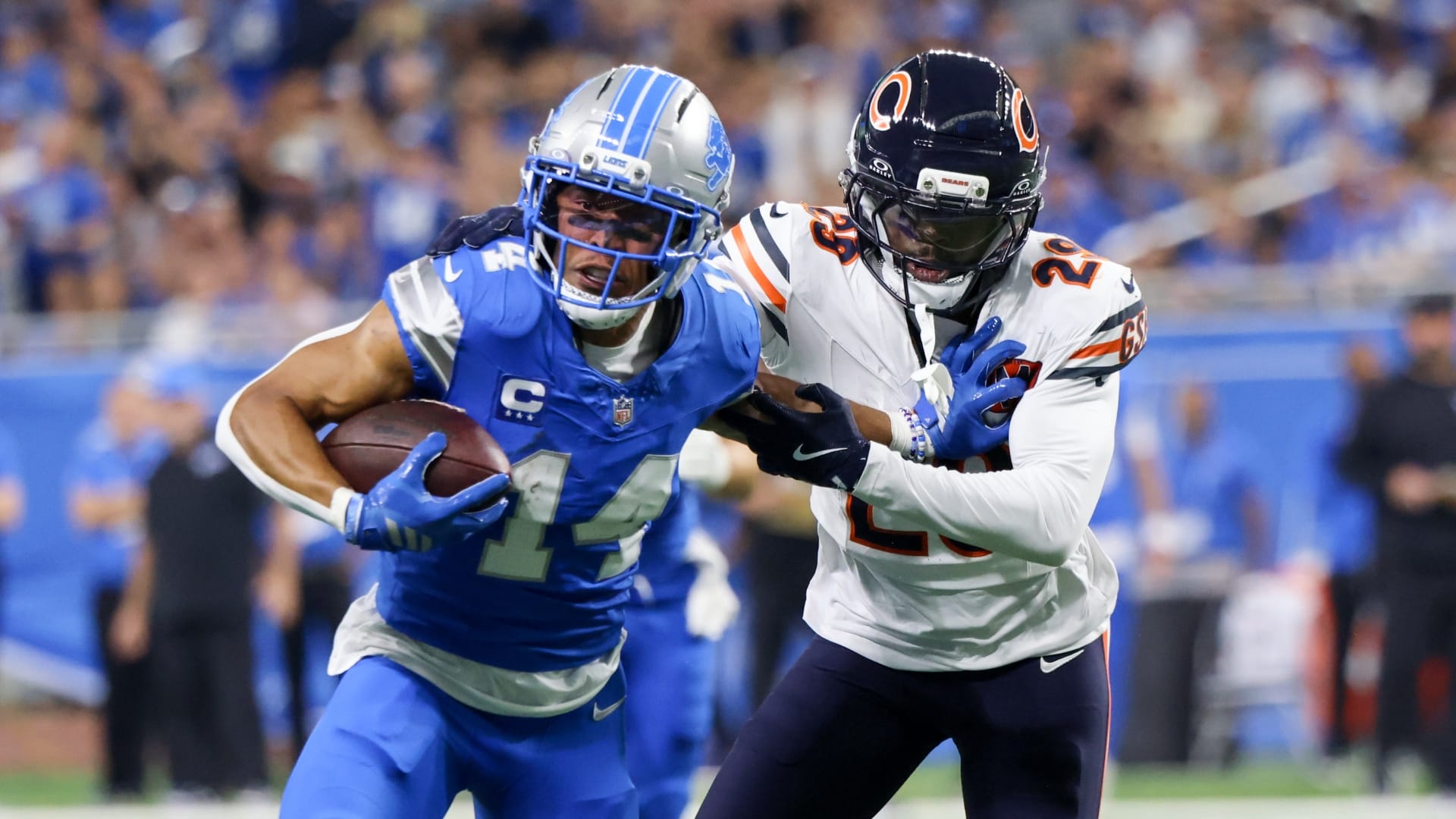 Detroit Lions wide receiver Amon-Ra St. Brown (14) carries the ball defended by Chicago Bears cornerback Tyrique Stevenson (29) during the first quarter at Ford Field.