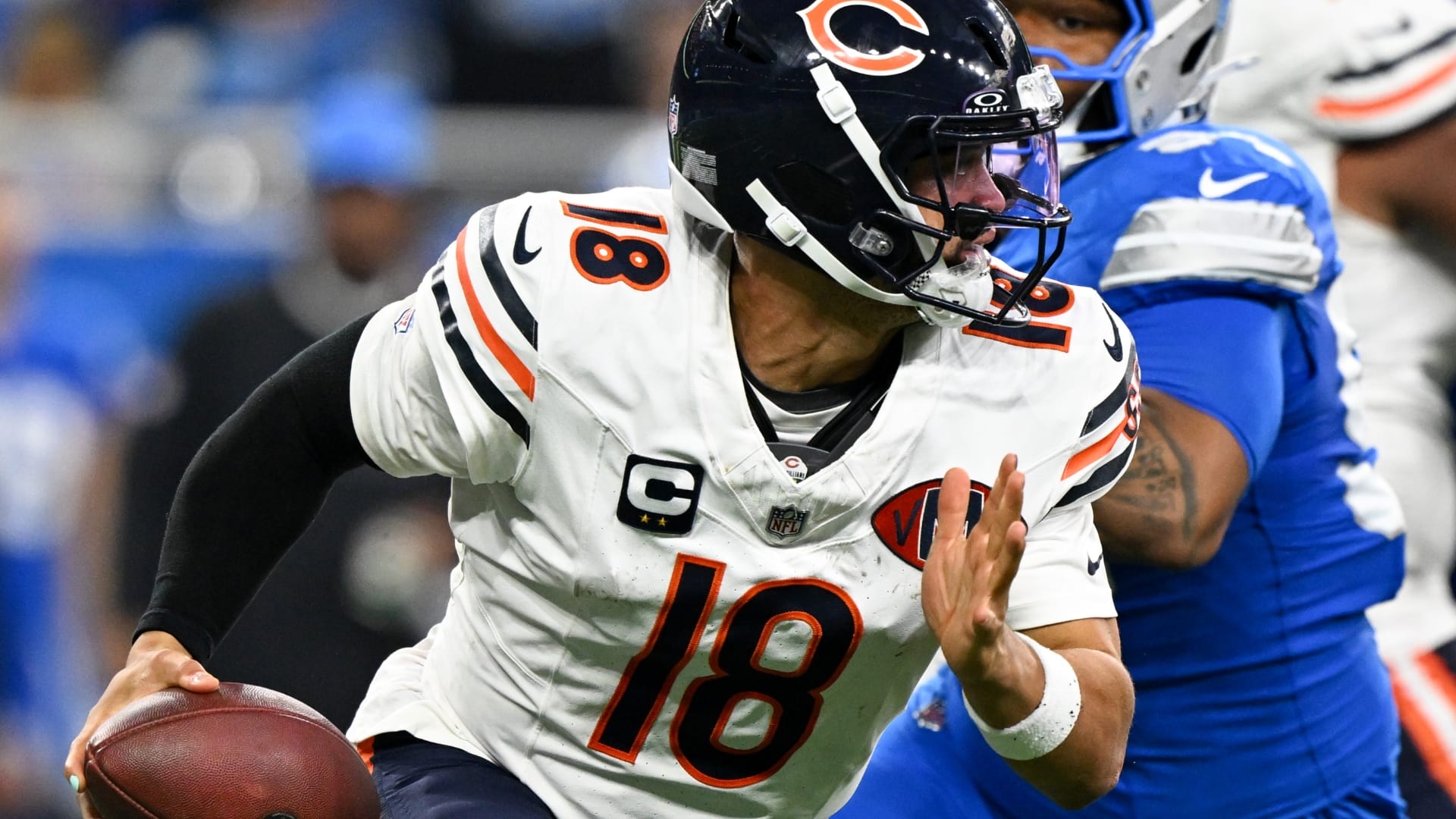 Chicago Bears quarterback Caleb Williams (18) scrambles with the ball against the Detroit Lions during the second half of the game at Ford Field.