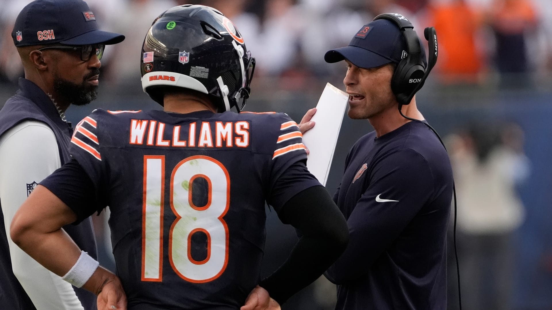 Chicago Bears head coach Ben Johnson talks with quarterback Caleb Williams (18) against the Dallas Cowboys during the second half at Soldier Field.