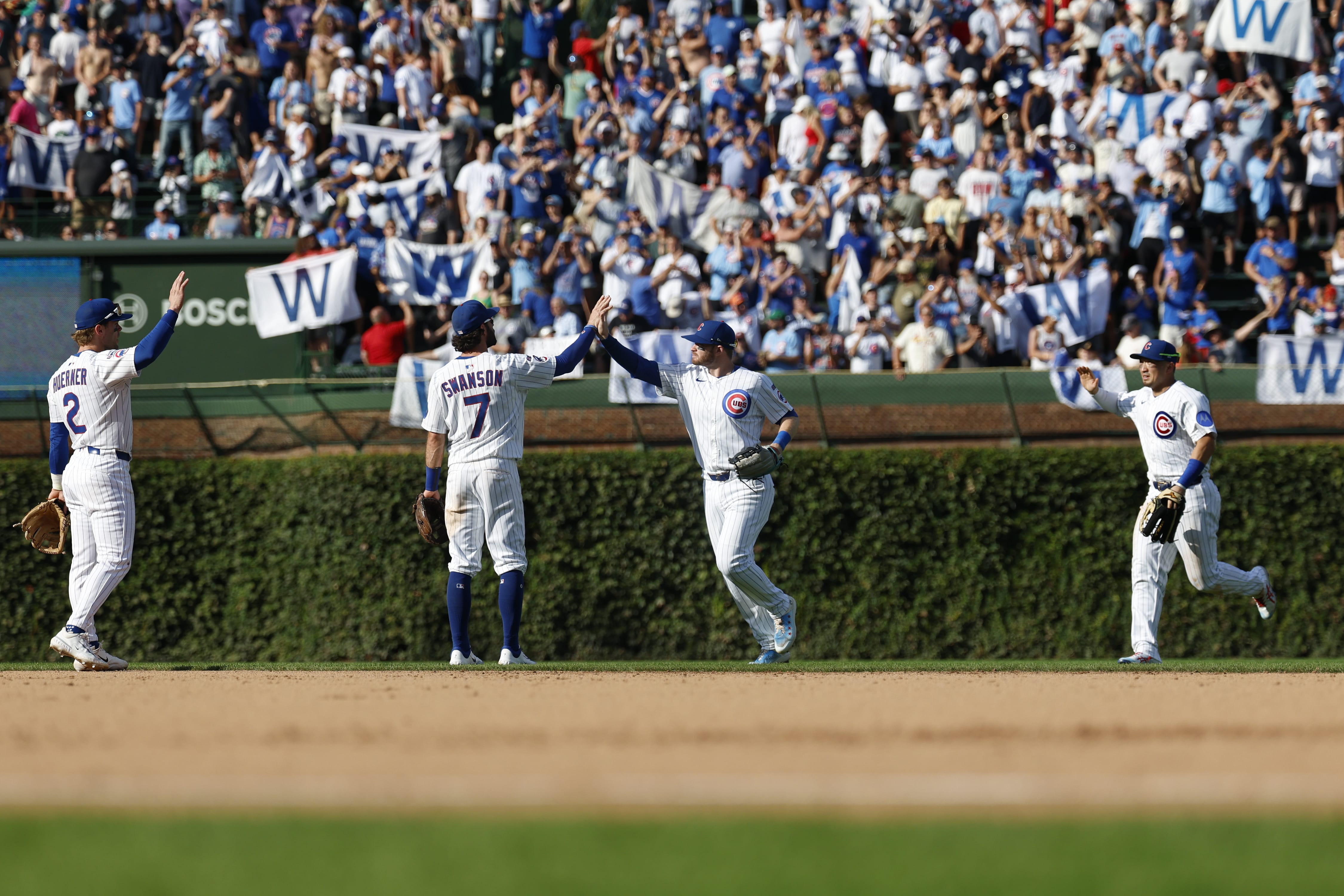 Sep 27, 2025; Chicago, Illinois, USA; Chicago Cubs players celebrate after defeating the St. Louis Cardinals in a baseball game at Wrigley Field.