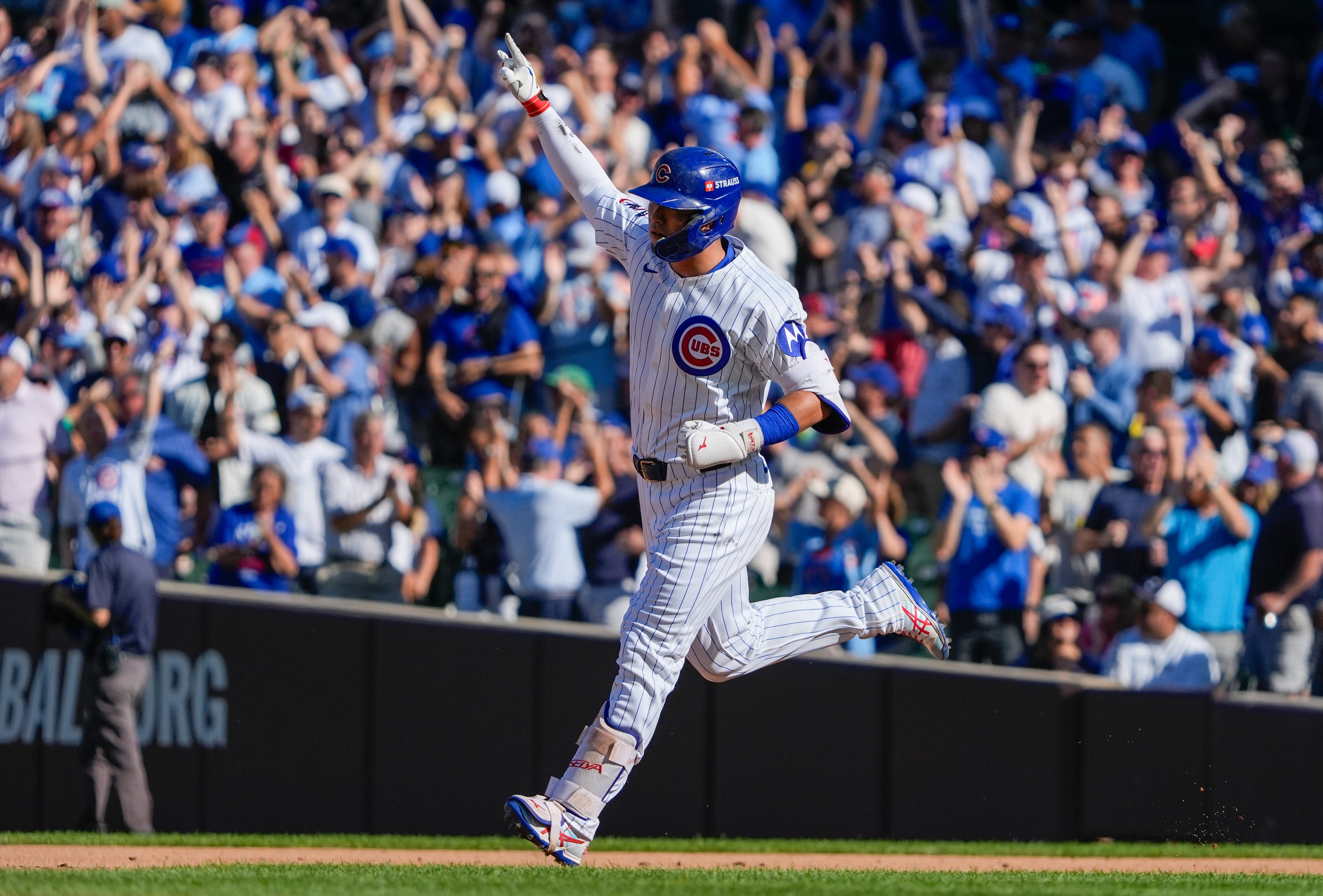 Sep 30, 2025; Chicago, Illinois, USA; Chicago Cubs outfielder Seiya Suzuki (27) rounds the bases after hitting a solo home run in the fifth inning against the San Diego Padres during game one of the Wildcard round for the 2025 MLB playoffs at Wrigley Field.
