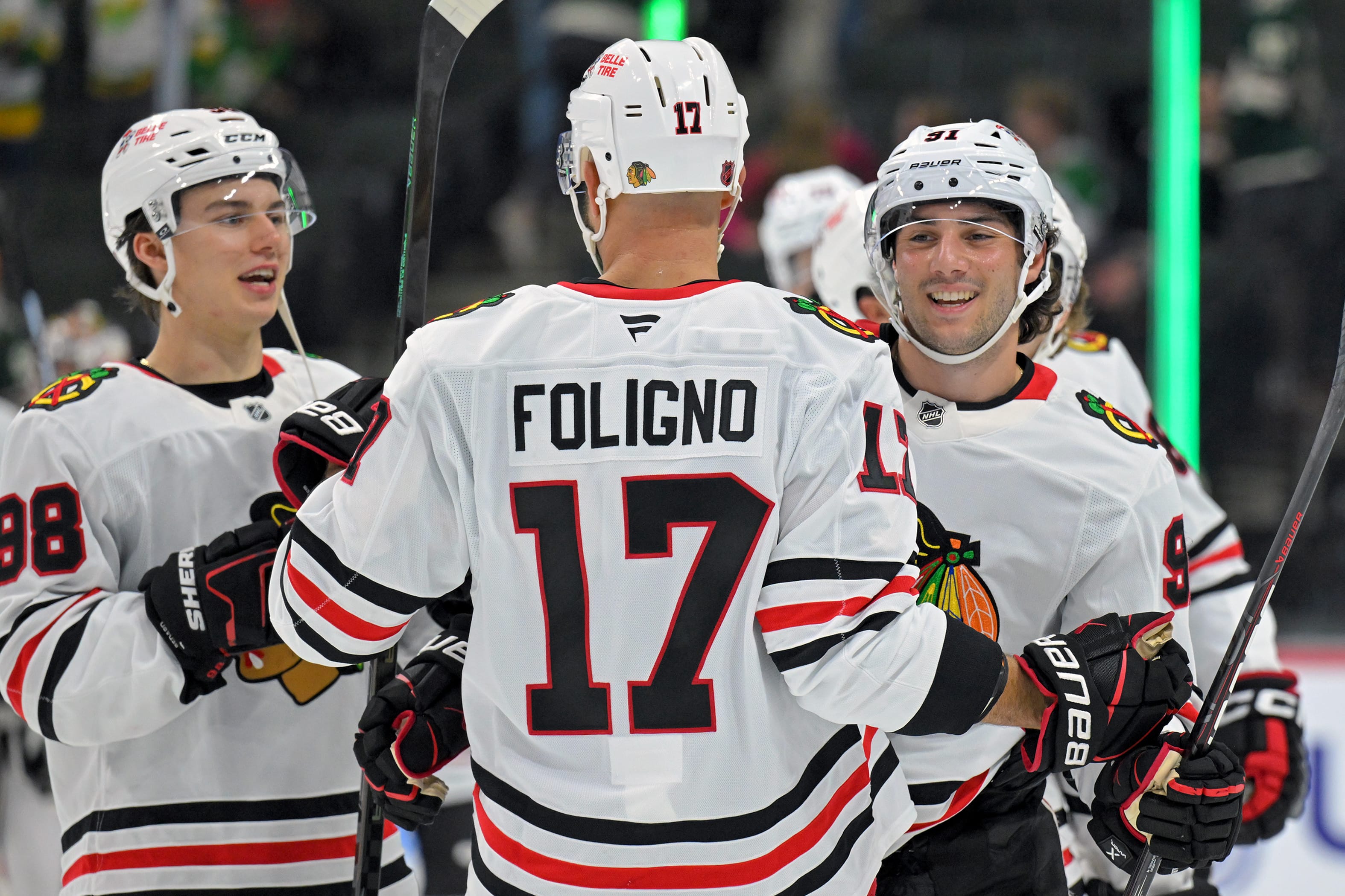 Sep 28, 2025; Saint Paul, Minnesota, USA; Chicago Blackhawks forward Nick Foligno (17), forward Connor Bedard (98), and forward Frank Nazar (91) celebrate a victory over the Minnesota Wild at Xcel Energy Center.