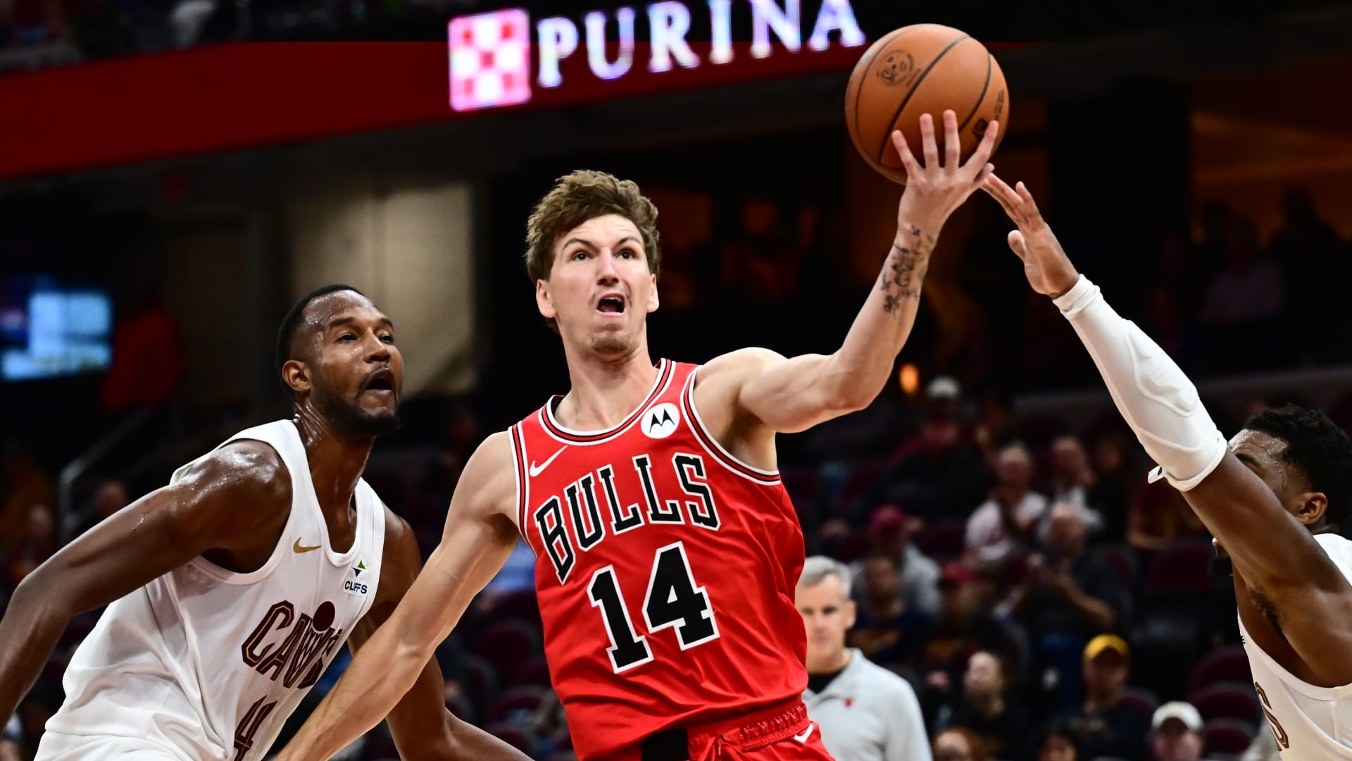Chicago Bulls forward Matas Buzelis (14) drives to the basket between Cleveland Cavaliers forward Evan Mobley (4) and guard Donovan Mitchell (45) during the second half at Rocket Arena.