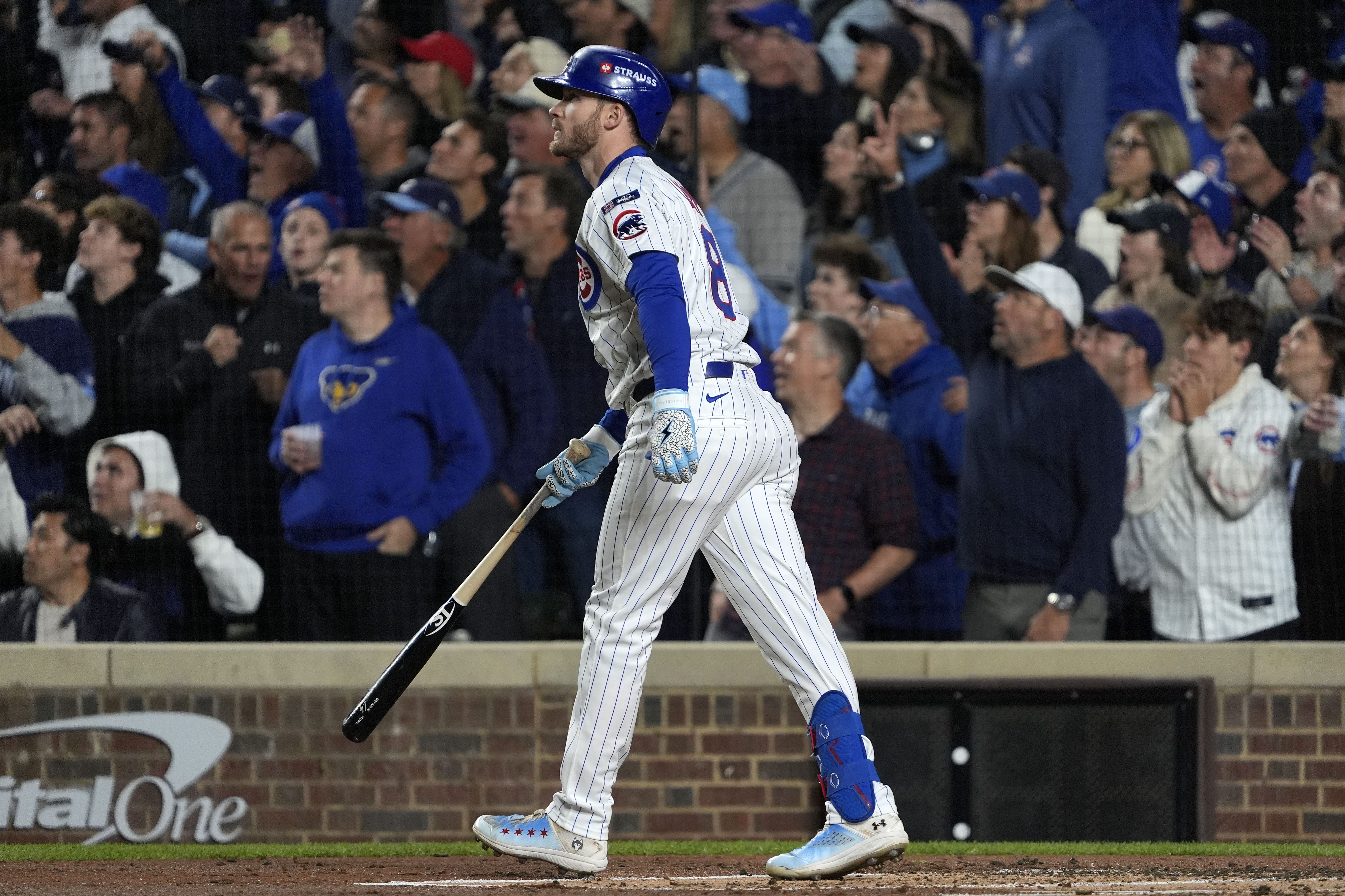 Oct 9, 2025; Chicago, Illinois, USA; Chicago Cubs left fielder Ian Happ (8) hits a three run home run against the Milwaukee Brewers during the first inning for game four of the NLDS round for the 2025 MLB playoffs at Wrigley Field.