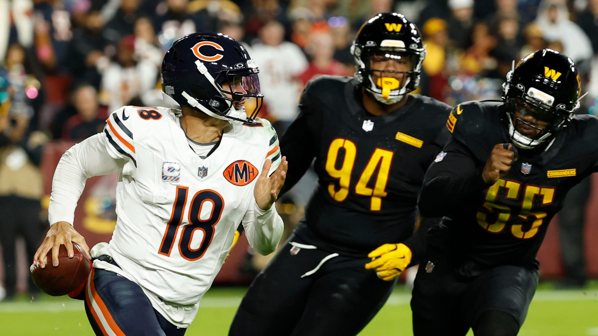 Oct 13, 2025; Landover, Maryland, USA; Chicago Bears quarterback Caleb Williams (18) scrambles from Washington Commanders nose tackle Daron Payne (94) and Commanders defensive end Jacob Martin (55) during the third quarter at Northwest Stadium. Mandatory Credit: Geoff Burke-Imagn Images