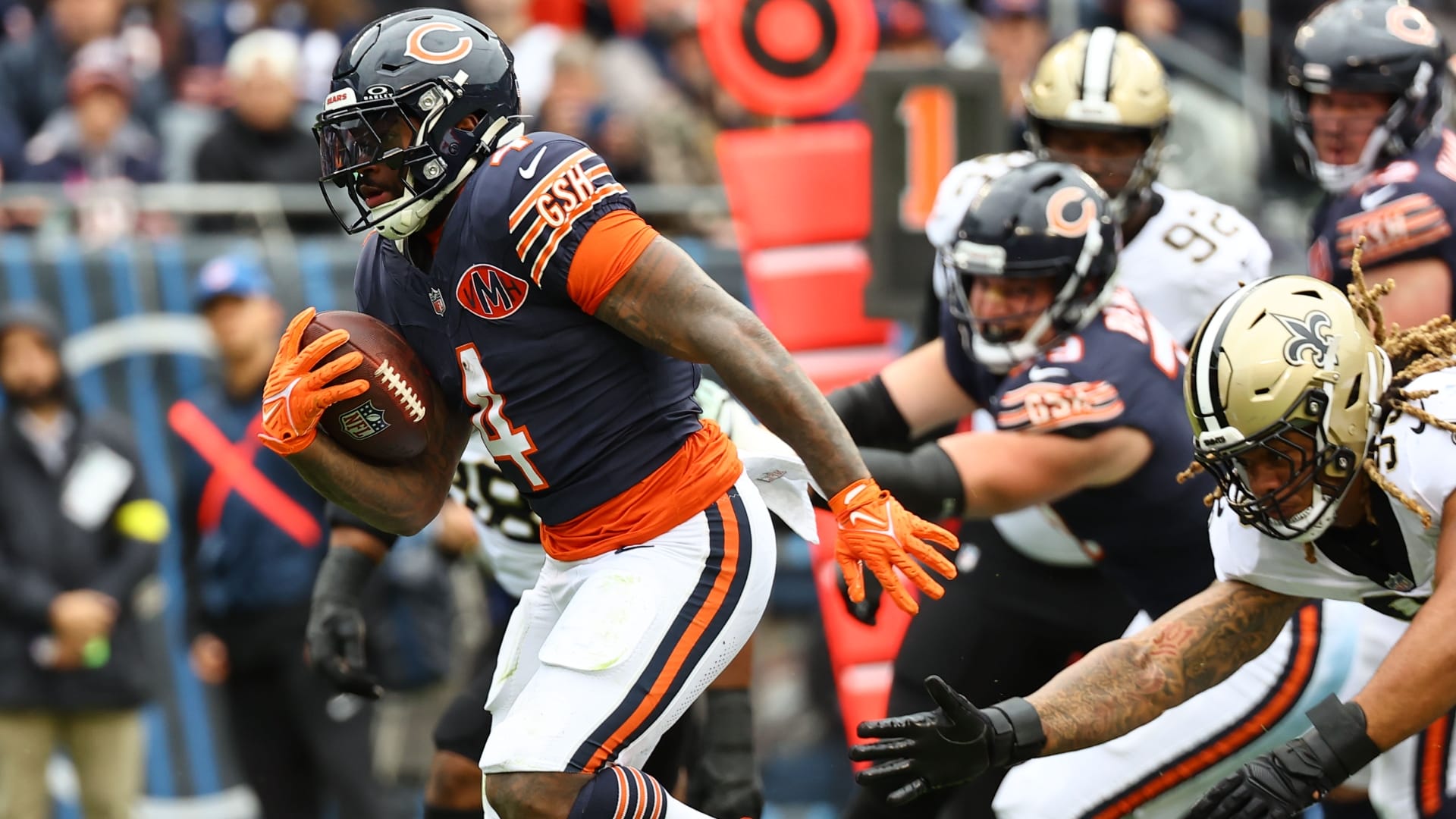 Oct 19, 2025; Chicago, Illinois, USA; Chicago Bears running back D'Andre Swift (4) rushes the ball for a touchdown against the New Orleans Saints during the second quarter at Soldier Field.
