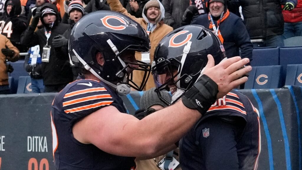 Chicago Bears quarterback Caleb Williams (18) celebrates with center Drew Dalman (52) after scoring the game-winning touchdown against New York Giants during the fourth quarter at Soldier Field. Mandatory Credit: David Banks-Imagn Images