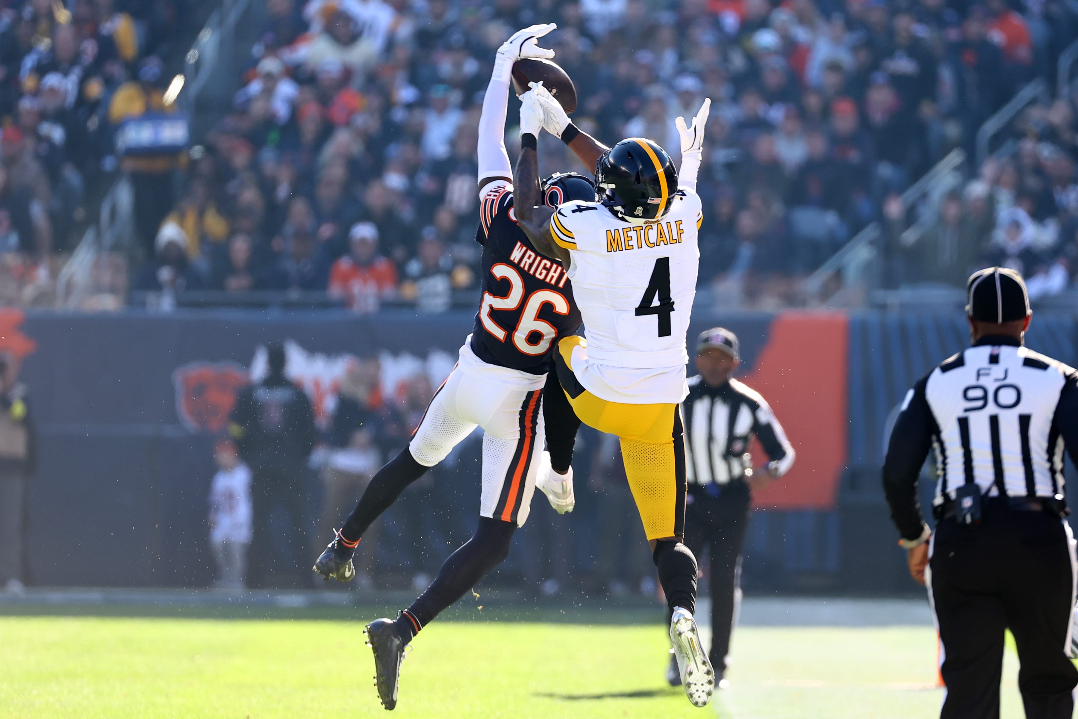 Chicago Bears cornerback Nahshon Wright (26) intercepts a pass against Pittsburgh Steelers wide receiver DK Metcalf (4) during the first half at Soldier Field. Mandatory Credit: Mike Dinovo-Imagn Images