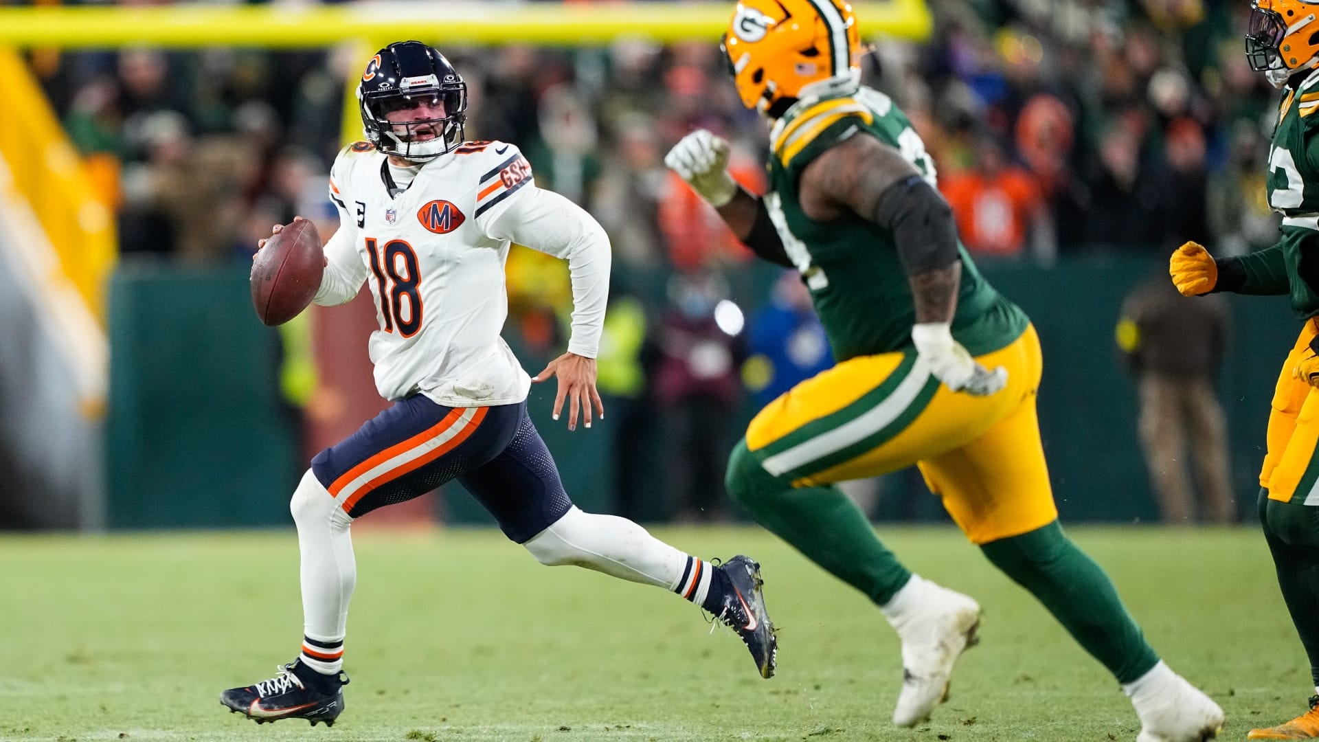 Dec 7, 2025; Green Bay, Wisconsin, USA; Chicago Bears quarterback Caleb Williams (18) scrambles out of the pocket in the third quarter against the Green Bay Packers at Lambeau Field.