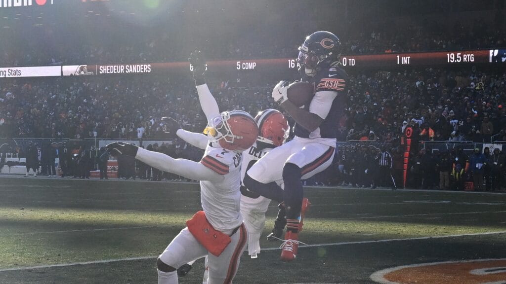Chicago Bears wide receiver DJ Moore (2) catches a pass from QB Caleb Williams for a touchdown against Cleveland Browns cornerback Tyson Campbell (7) and Cleveland Browns safety Grant Delpit (9) during the third quarter at Soldier Field. Mandatory Credit: Matt Marton-Imagn Images